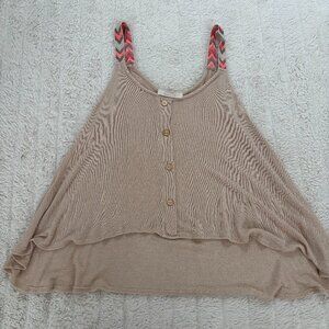 Delicate and feminine, this lightweight white blouse features tiered ruffle laye